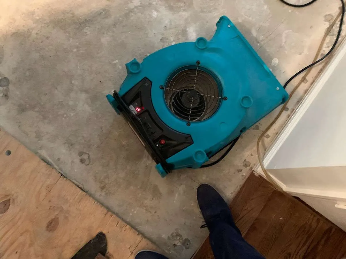 Air mover drying subfloor during Commercial Water Damage Restoration in Topeka